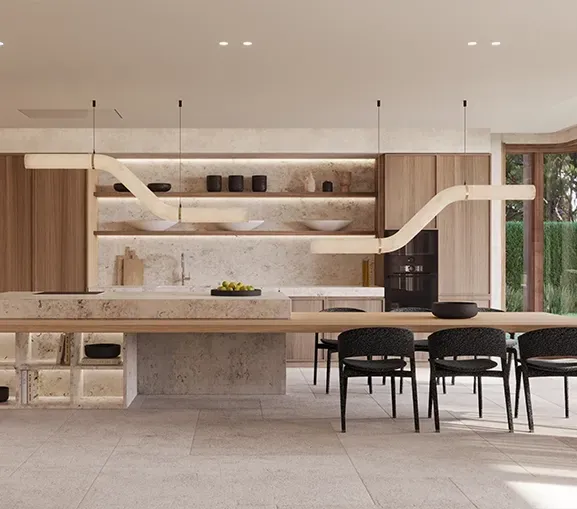 Open-plan luxury kitchen with natural stone finishes, custom lighting, and floor-to-ceiling windows overlooking greenery.