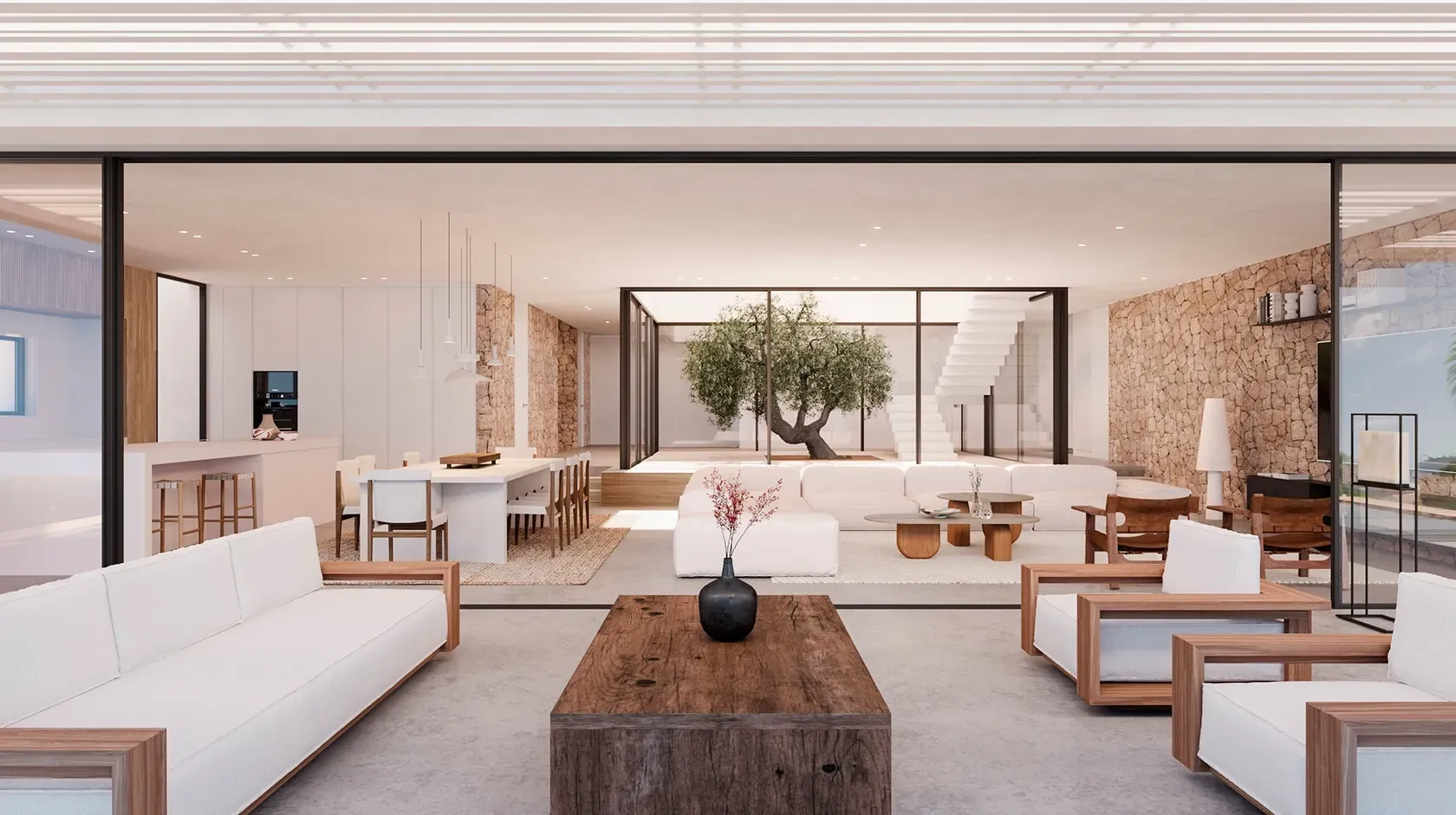 Terrace view into a modern living space with dining area and indoor olive tree, designed with stone walls, wood tones, and soft neutral colors.
