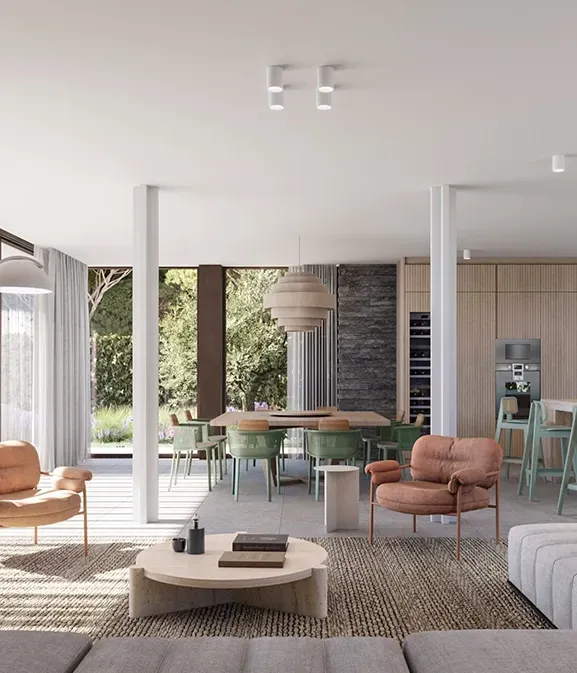 Open-plan interior with kitchen, dining, and living space flooded with natural light.