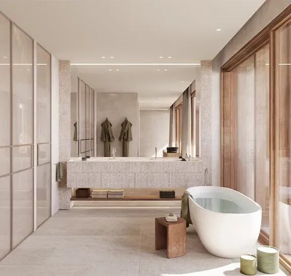 Modern master bathroom with freestanding bathtub, natural stone finishes, and warm light creating a spa-like luxury.
