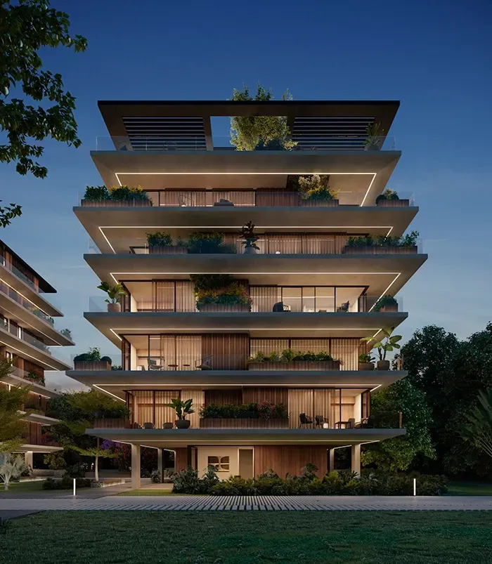 Night view of a luxury residential building by LUV Studio, with warm lighting, modern terraces, and rich landscaping, blending elegance with serenity.