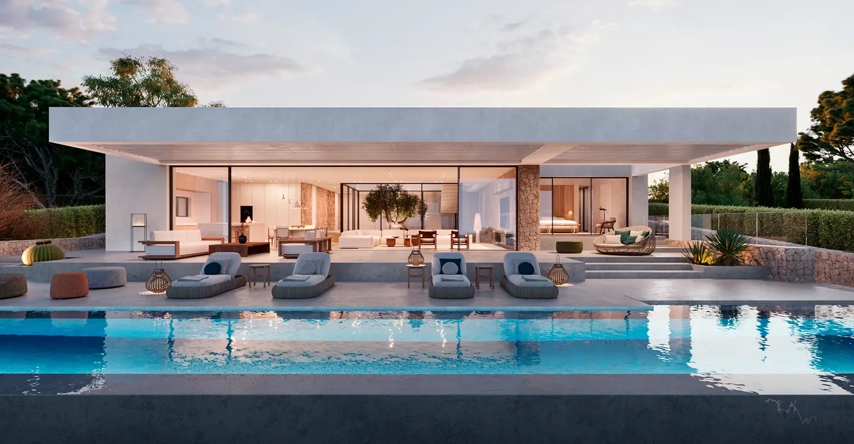 Night view of the villa exterior with illuminated interiors, pool reflections, and seamless transition between indoor and outdoor spaces.