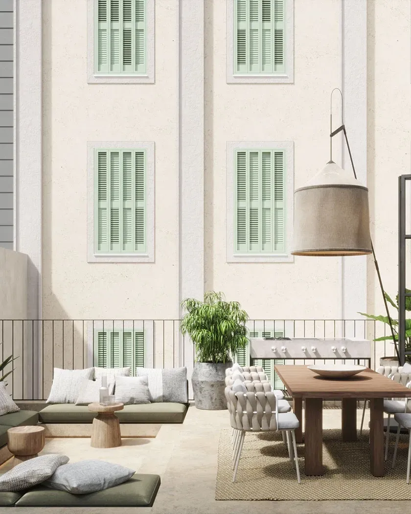 Charming terrace with outdoor dining and lounge area, surrounded by greenery and soft Mediterranean light.