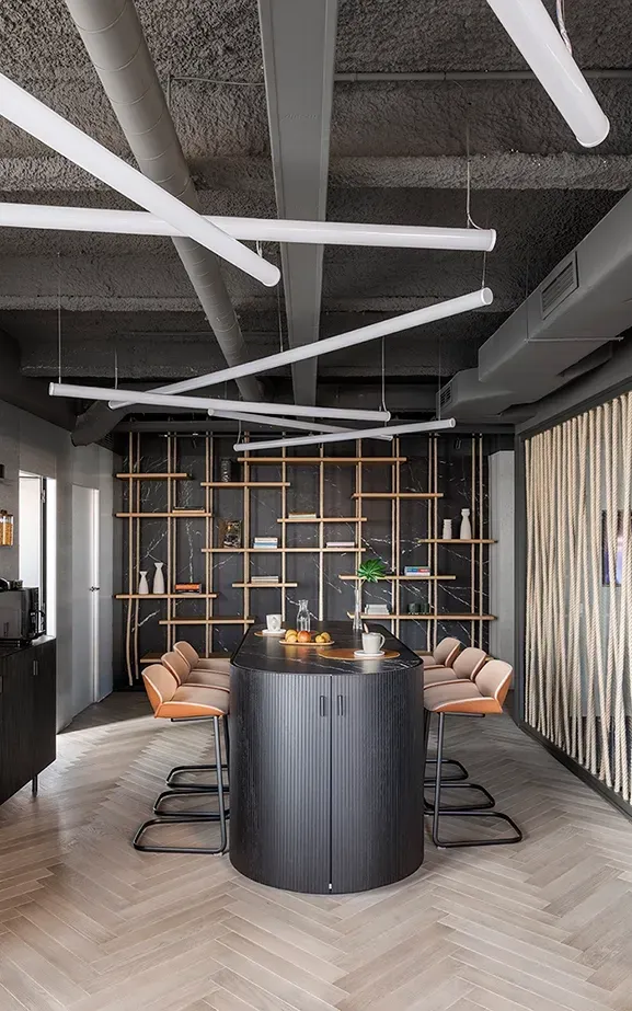 Contemporary office kitchen with tall bar table, wood finishes and minimalist shelving at LUV Studio