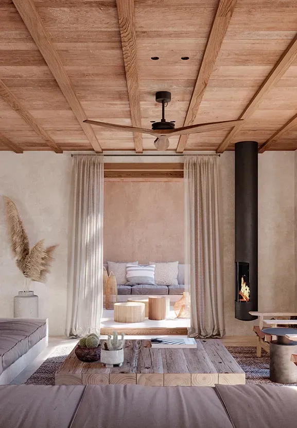 Warm-toned interior with built-in seating, fireplace, and wood ceilings opening to lush exterior views.