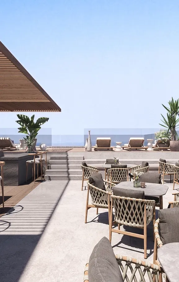 Rooftop lounge and bar with ocean view, sunbeds and outdoor dining area at Carlyle