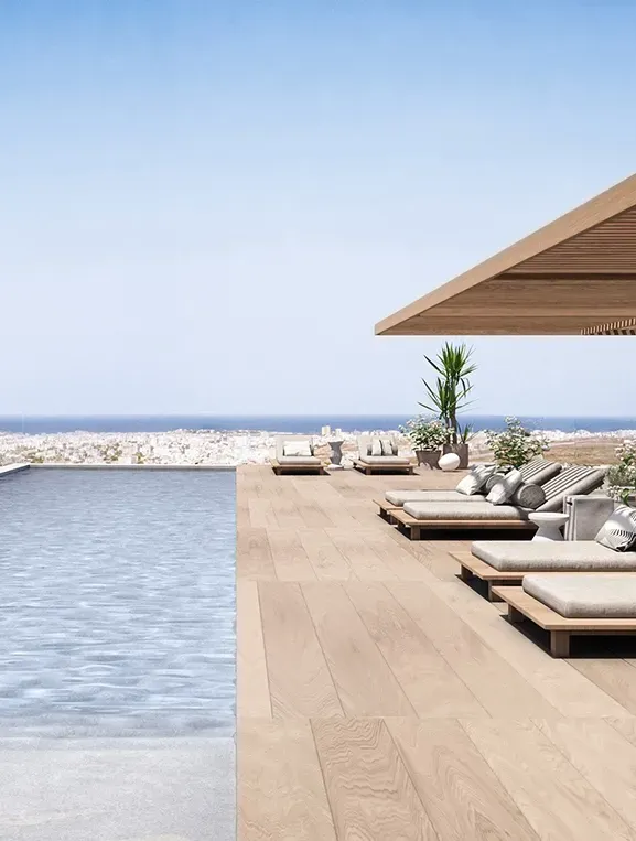 Luxury architectural entrance of Carlyle with lush landscaping and vertical wood elements