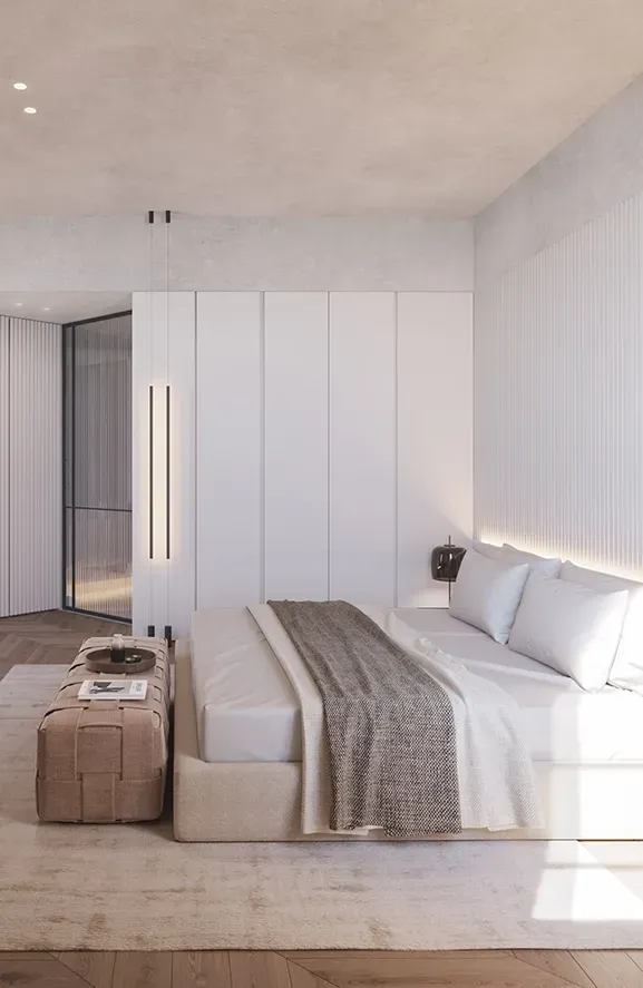 Serene master bedroom with neutral palette, wood herringbone flooring, and custom cabinetry, designed for comfort and refined minimalism.