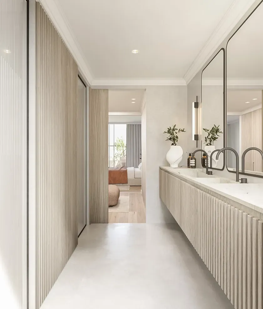 Modern bathroom with double marble sinks, ribbed wood cabinetry, and elegant lighting design.