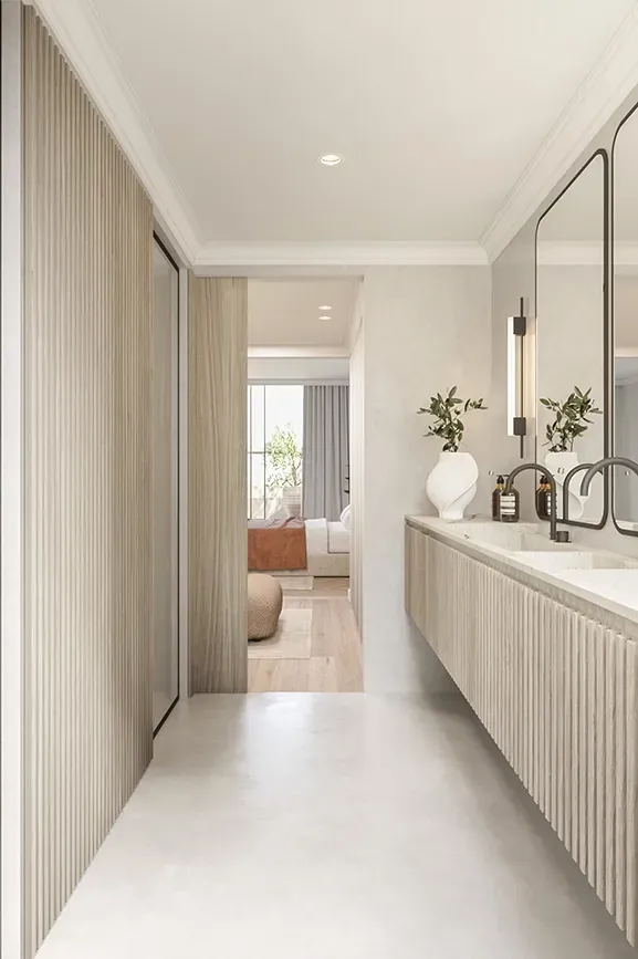 Modern bathroom with double marble sinks, ribbed wood cabinetry, and elegant lighting design.