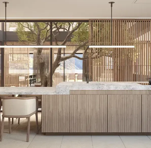 Contemporary luxury kitchen featuring stone countertops, wood paneling, and open views to a landscaped patio.