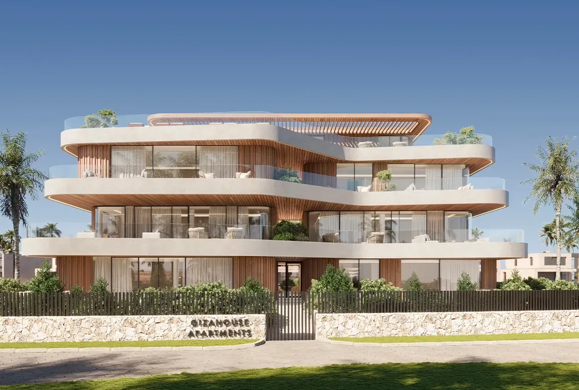 Frontal view of the full residential building with organic lines and Mediterranean landscaping.