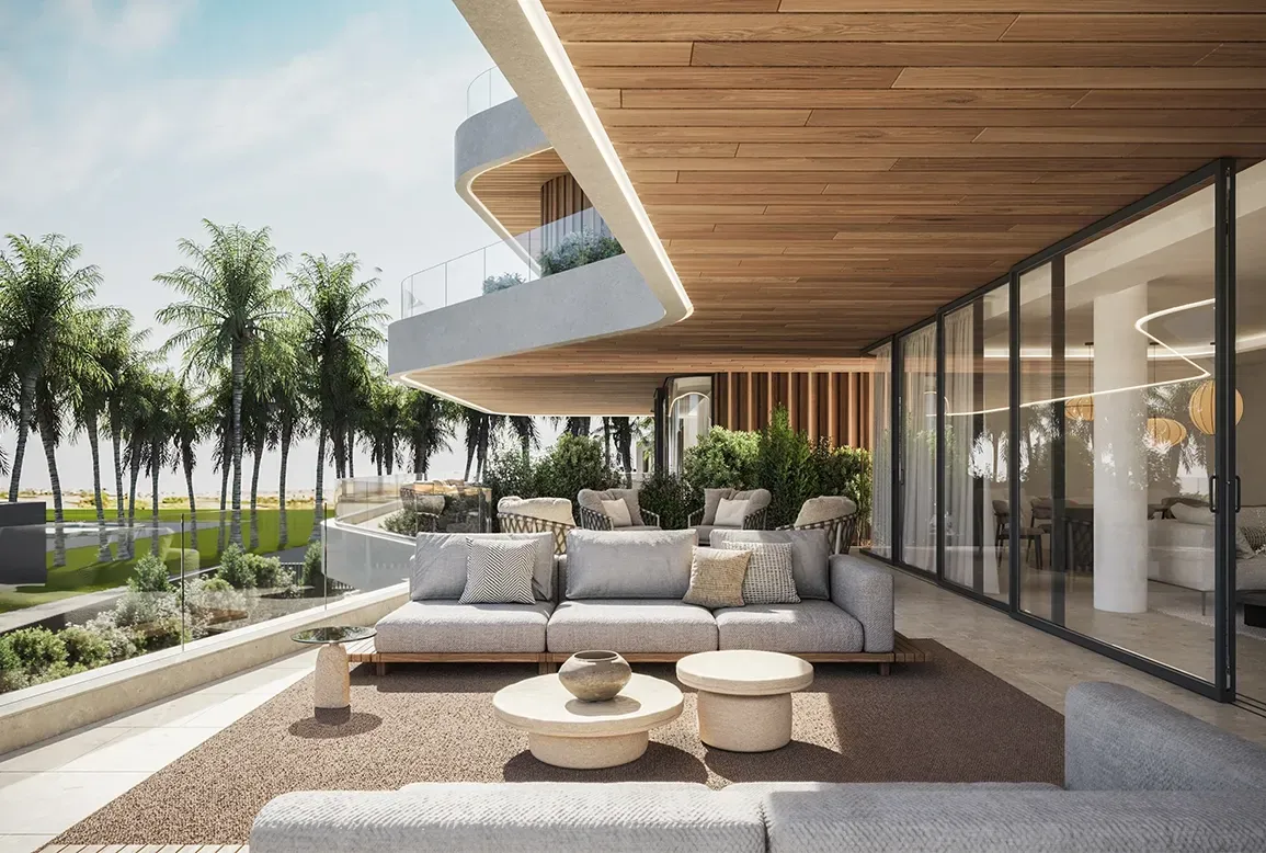 Outdoor lounge on a covered terrace with views of lush palms and a sculptural ceiling.