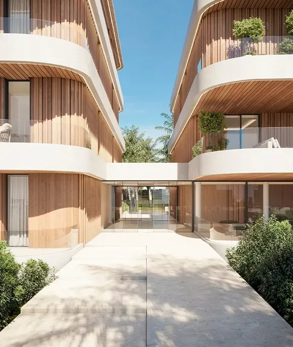 Elegant access corridor between two wood-clad apartment buildings designed by LUV Studio under clear blue skies.