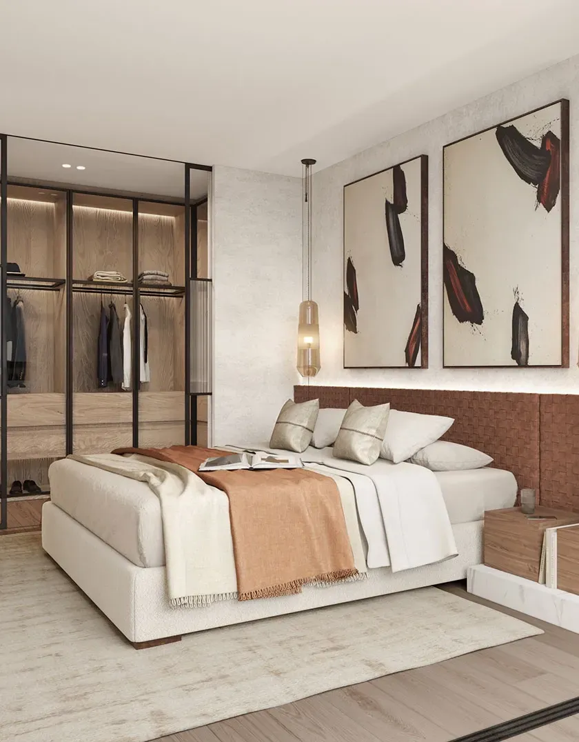 Elegant bedroom with open walk-in closet, woven headboard, warm bedding and framed art, styled with a sophisticated yet relaxed aesthetic.