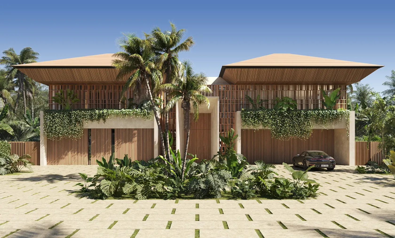 Refined entrance hall with tropical landscaping, natural textures, and elegant architectural composition in a high-end Punta Cana residence.