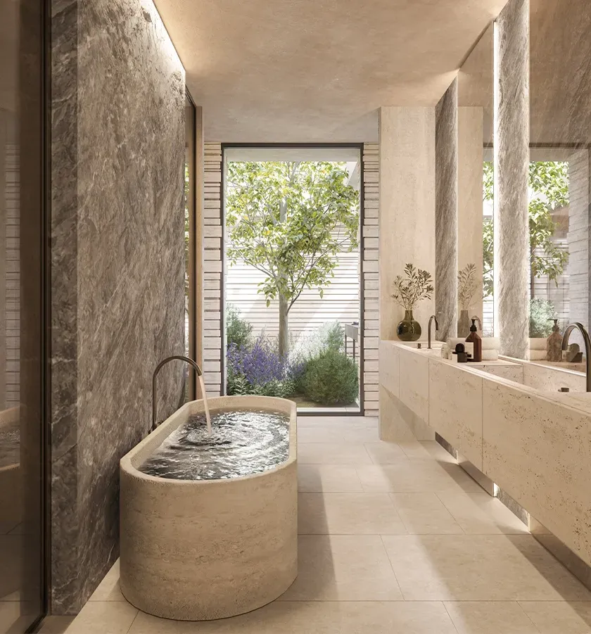 Elegant bathroom with stone textures, oval freestanding tub and garden views, reflecting luxury interior design.