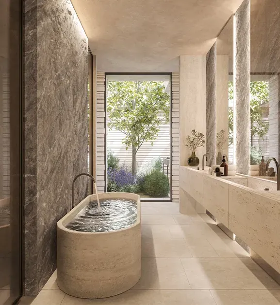 Elegant bathroom with stone textures, oval freestanding tub and garden views, reflecting luxury interior design.