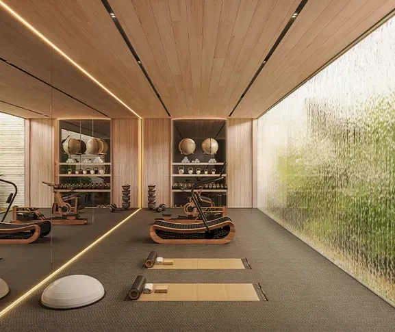 Sleek home gym with wooden ceiling, designer equipment and a glass wall with cascading water feature.