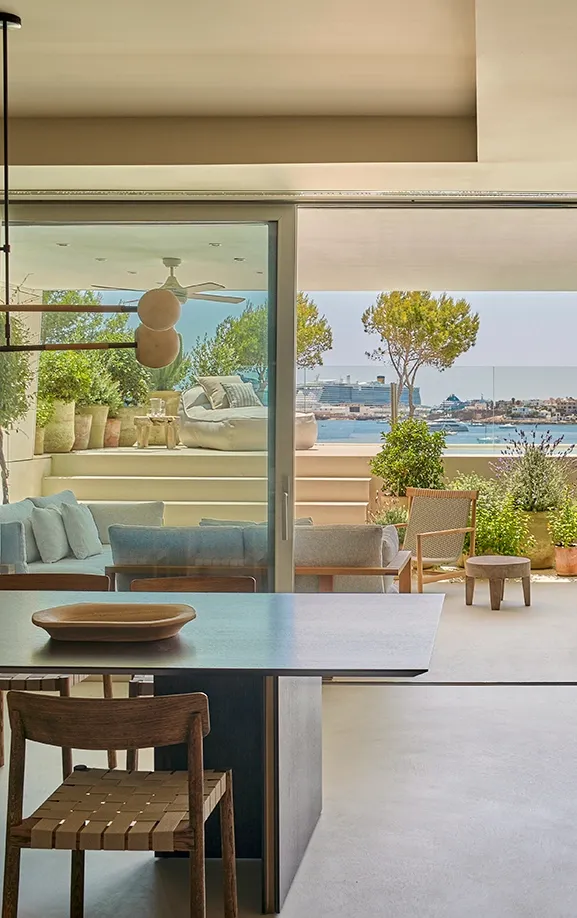Open-plan kitchen and dining room extending to terrace with Mediterranean sea views