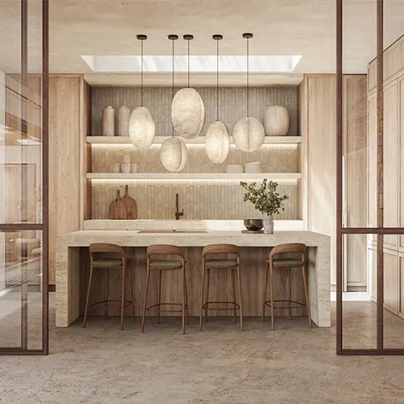 Refined kitchen design with natural stone island, sculptural pendant lighting, and warm wood tones in a luxury architectural setting.