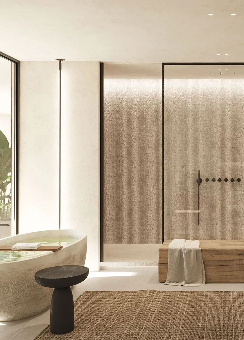 Spa-like master bathroom with textured walls, freestanding stone bathtub, double sinks, and natural tones, combining comfort and sophistication.