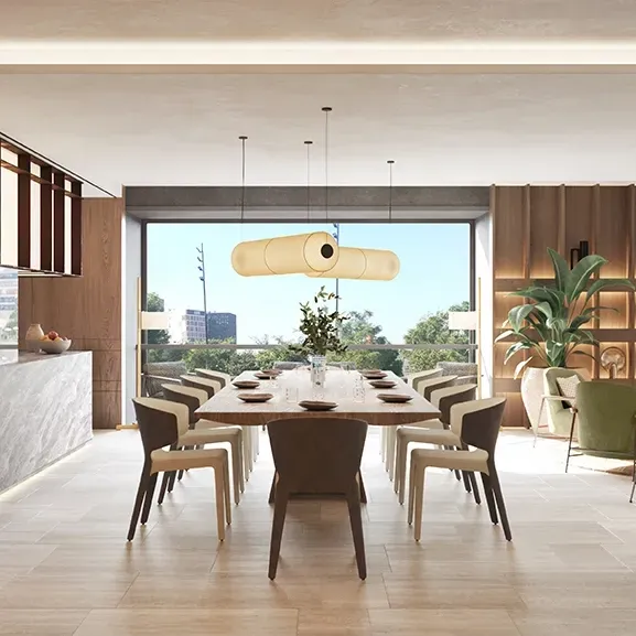 Contemporary dining area with long wooden table, sculptural lighting, and stylish green armchairs in a refined open-concept living space.