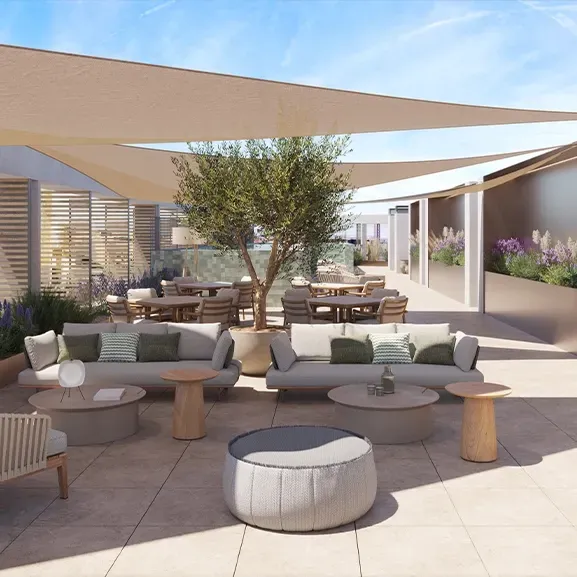 Elegant rooftop terrace with shaded lounge area, cozy seating, greenery, and modern outdoor kitchen for luxury al fresco living and relaxation.