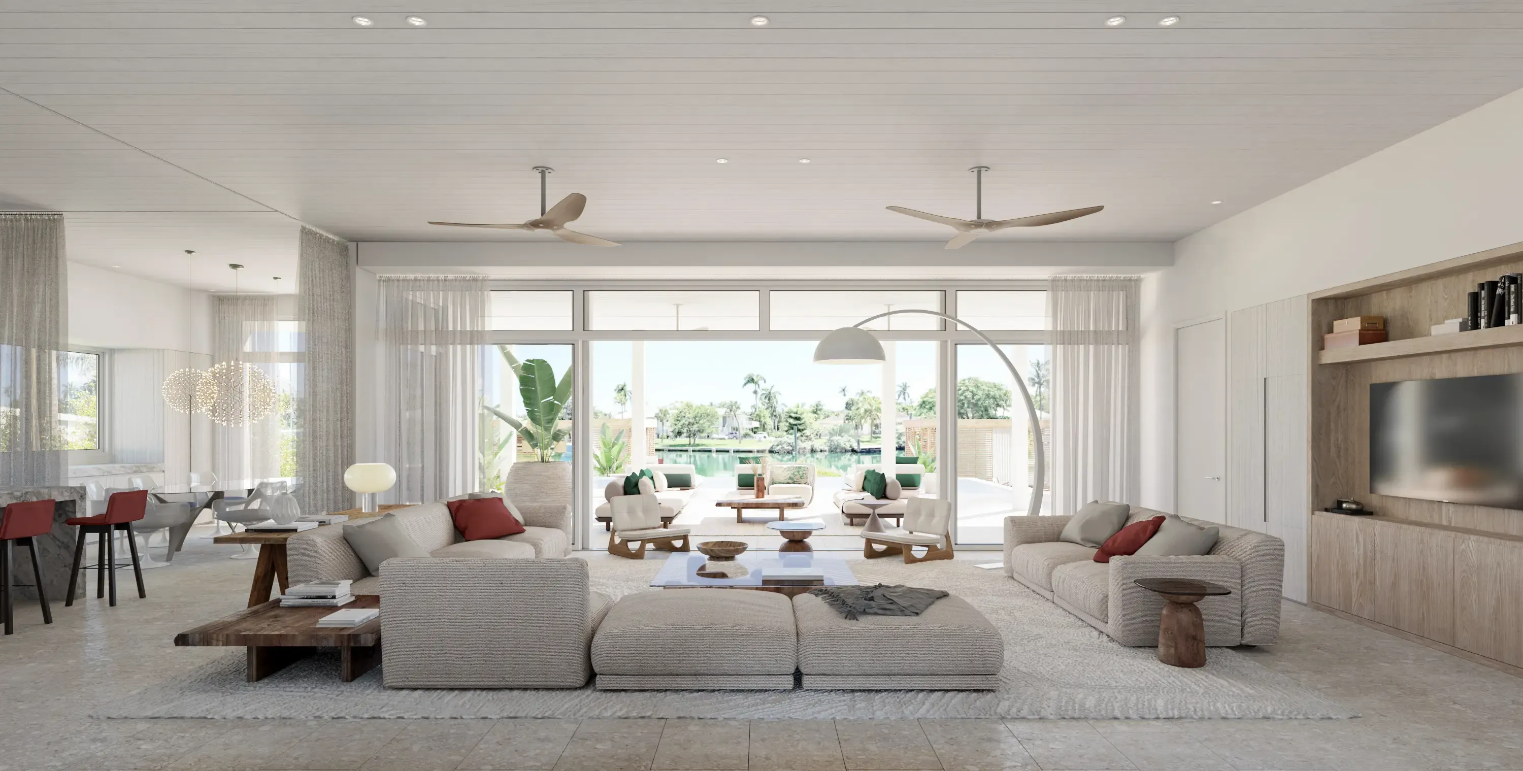 Spacious open-plan living room with neutral decor, panoramic windows, and views of the waterfront.
