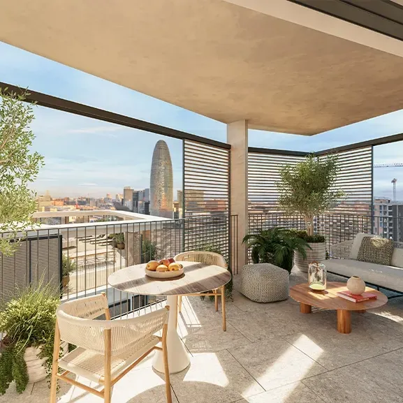 Beautifully designed terrace with lush greenery, elegant seating and open views of Barcelona, framed by modern wooden privacy panels.