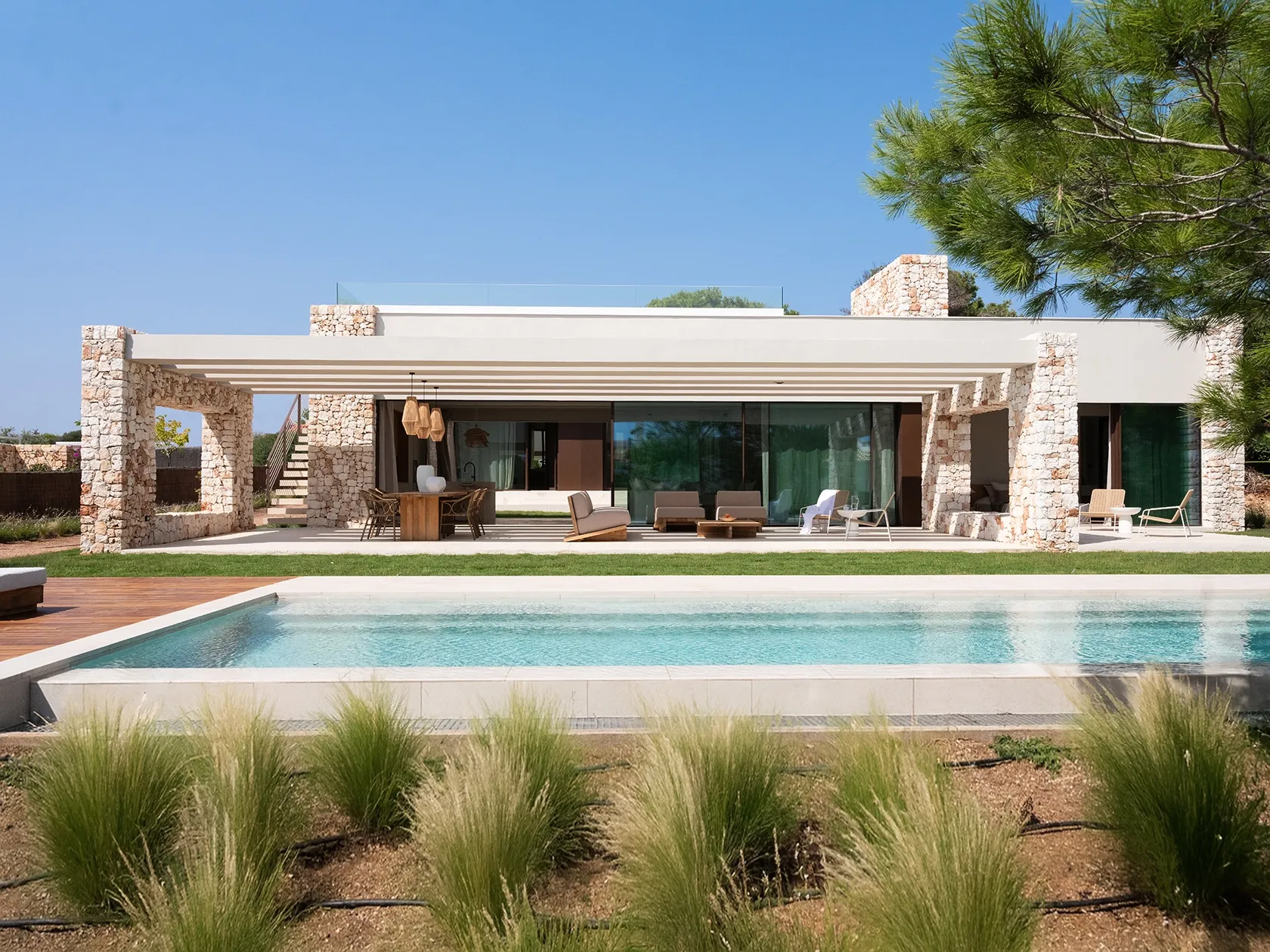 A contemporary façade rooted in tradition, blending lime stucco with natural textures.