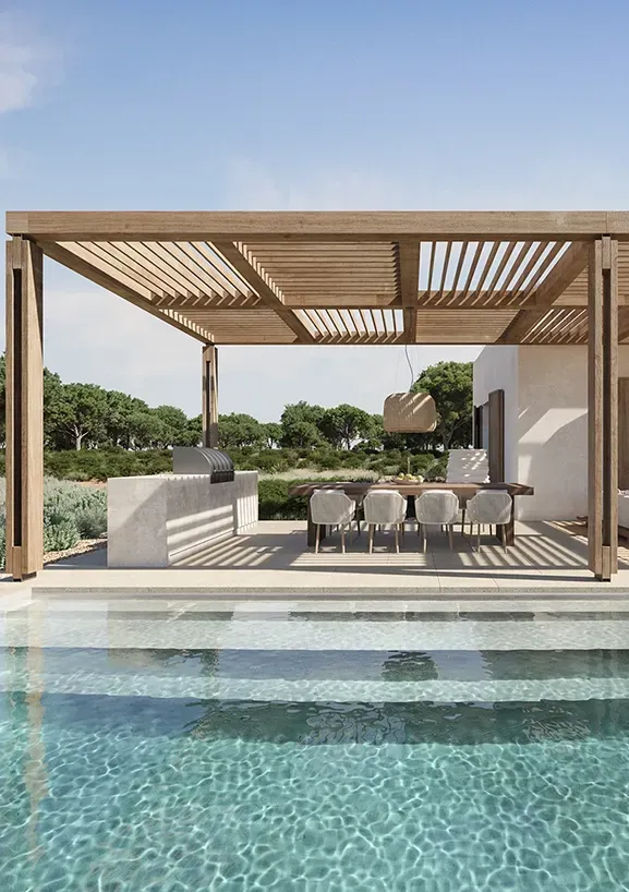 Outdoor dining area and pergola beside crystal-clear pool, set in a tranquil Mediterranean setting.