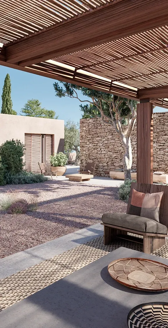 Covered outdoor lounge and dining area with Mediterranean landscaping at a LUV Studio luxury villa in Ibiza.