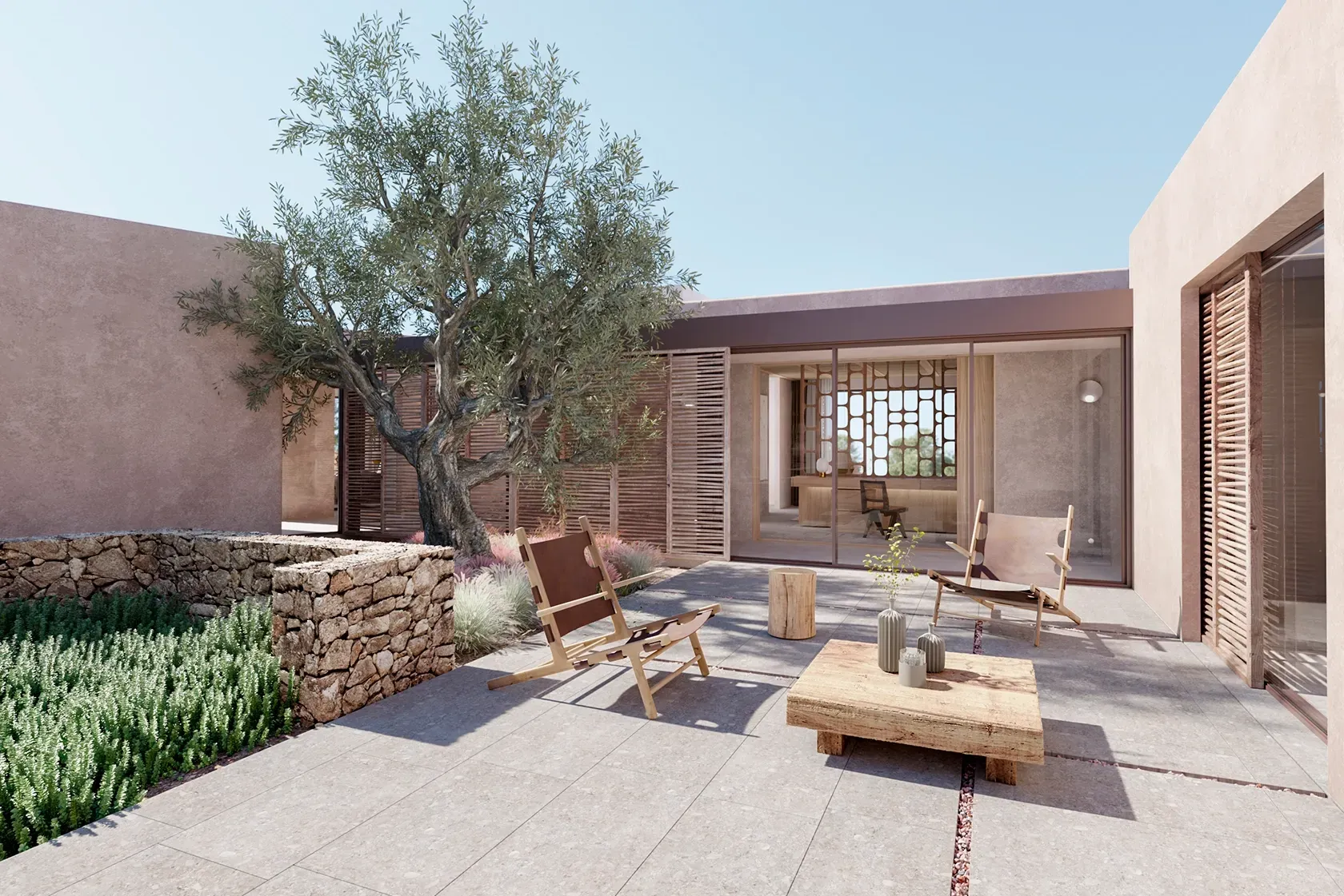 Tranquil courtyard with olive tree and wood furniture blending architecture and nature in LUV Studio Ibiza home.