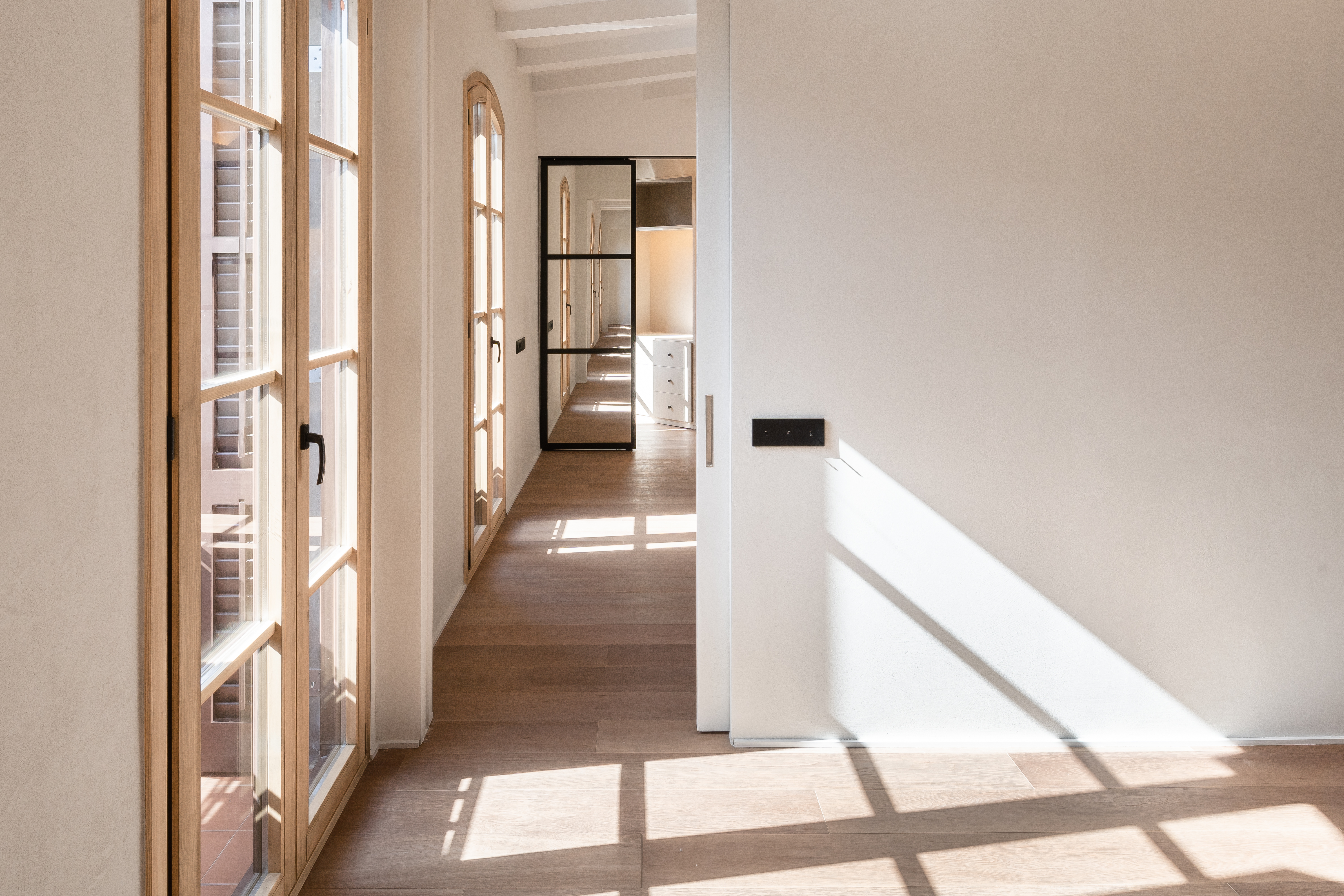 Hallway with natural light and clean architectural lines.