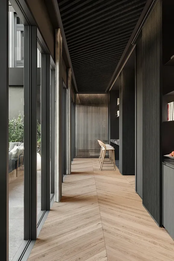 Modern corridor kitchen with wood flooring and open shelving facing lush terrace in LUV Studio Andorra workspace.