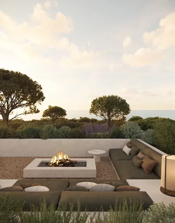 Outdoor lounge with sunken fire pit and built-in seating, offering a warm, intimate luxury experience.