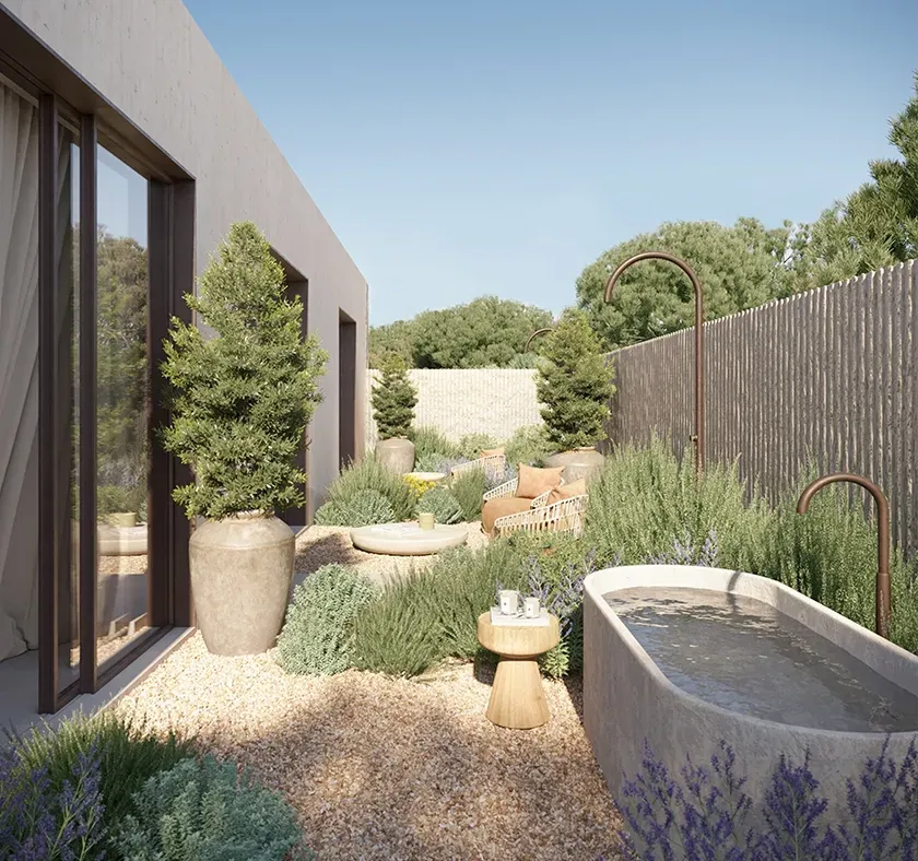 Outdoor bathtub set in natural stone with views of greenery, blending wellness and luxury architecture.