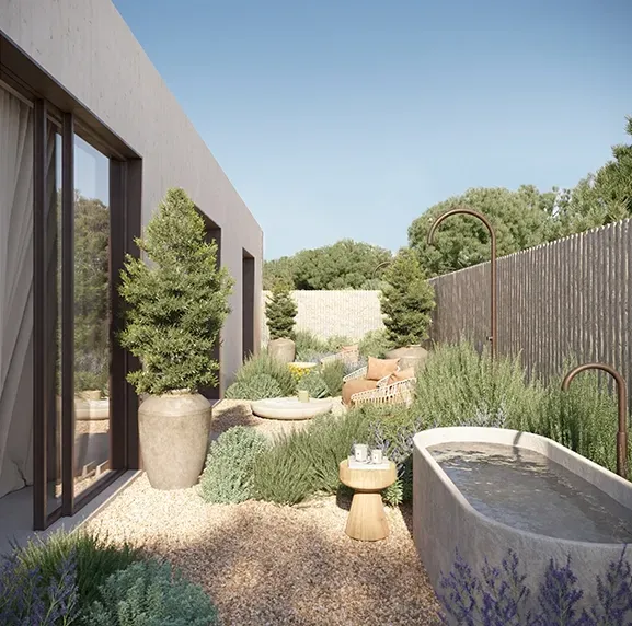 Outdoor bathtub set in natural stone with views of greenery, blending wellness and luxury architecture.