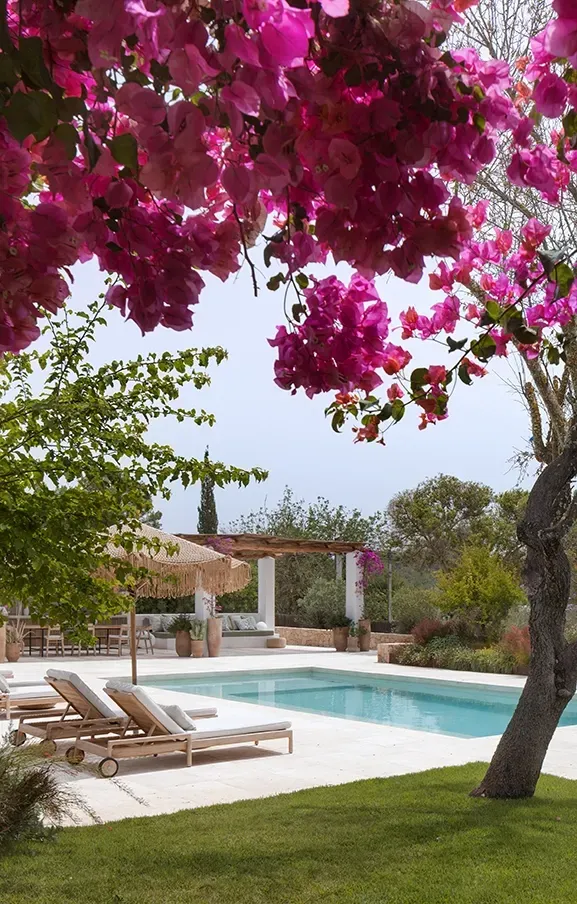 Framed by vivid bougainvillea, the elegant pool terrace blends luxury with nature, creating a vibrant, serene Mediterranean retreat.