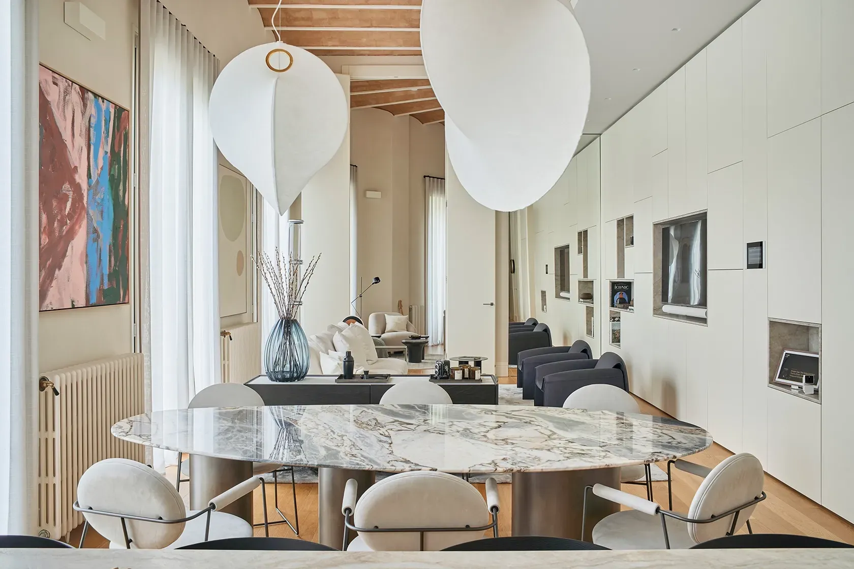 Open-plan dining space with natural textures, elegant lighting, and refined wood finishes creating an inviting ambiance.