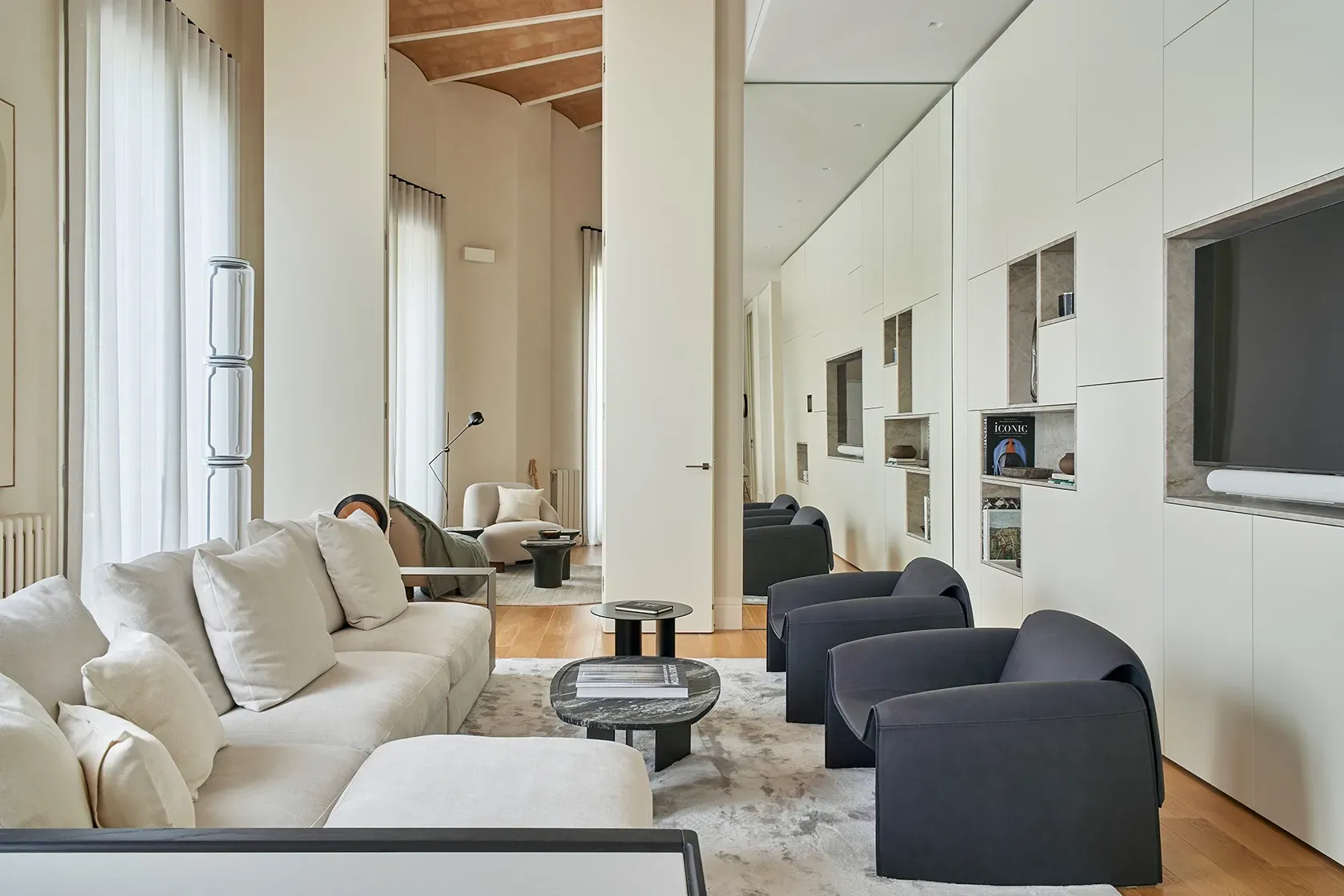Spacious living room with plush seating and warm wood accents, creating a harmonious balance between comfort and elegance.