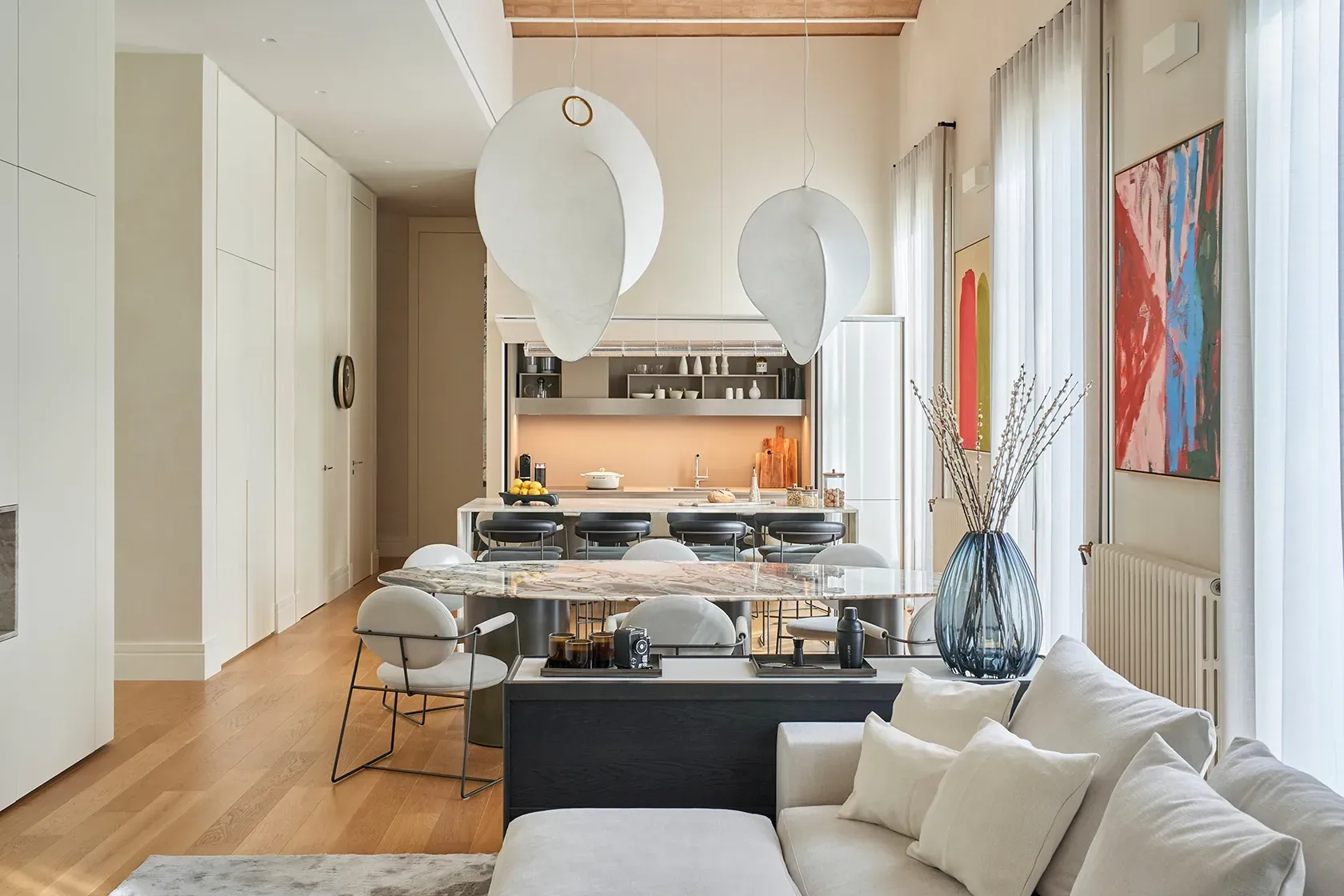 Elegant open-plan living and dining space blending neutral colors and soft textures in a luxurious setting.
