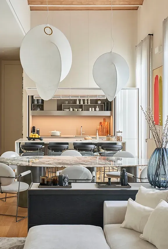 Elegant open-plan living and dining space blending neutral colors and soft textures in a luxurious setting.