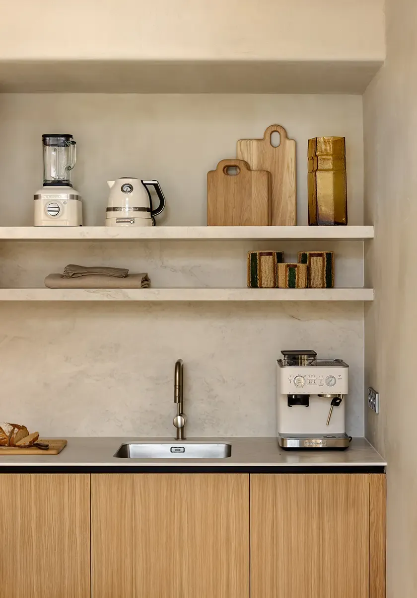 Contemporary kitchen detail with textured finishes and integrated wood cabinetry