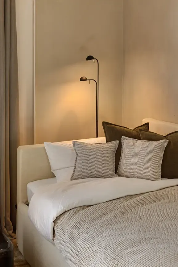 Minimalist guest bedroom with upholstered bed and neutral interior palette
