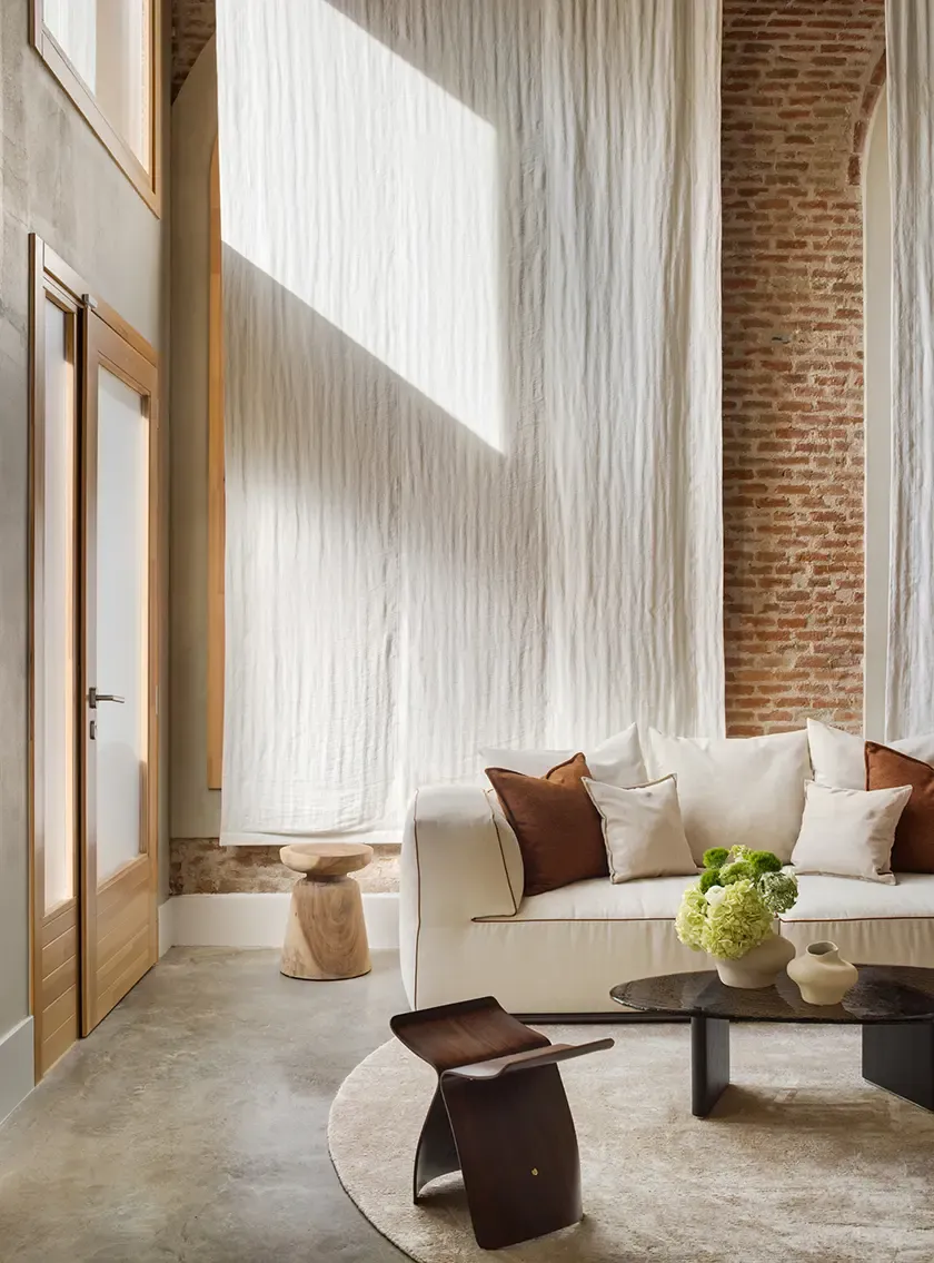 Detail of designer sofa and coffee table styling in modern loft interior