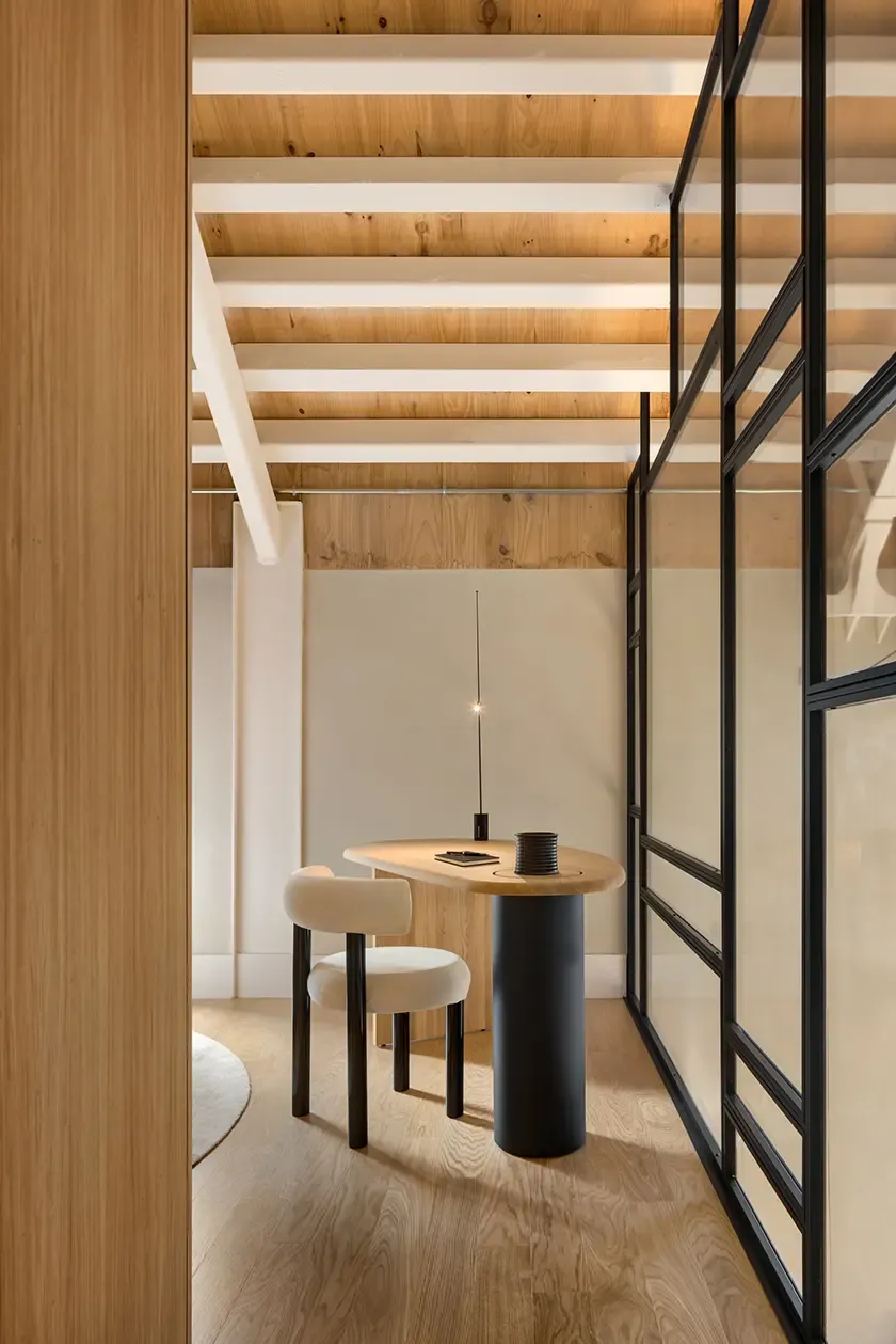 Contemporary home office corner with custom desk and black metal partition in luxury loft