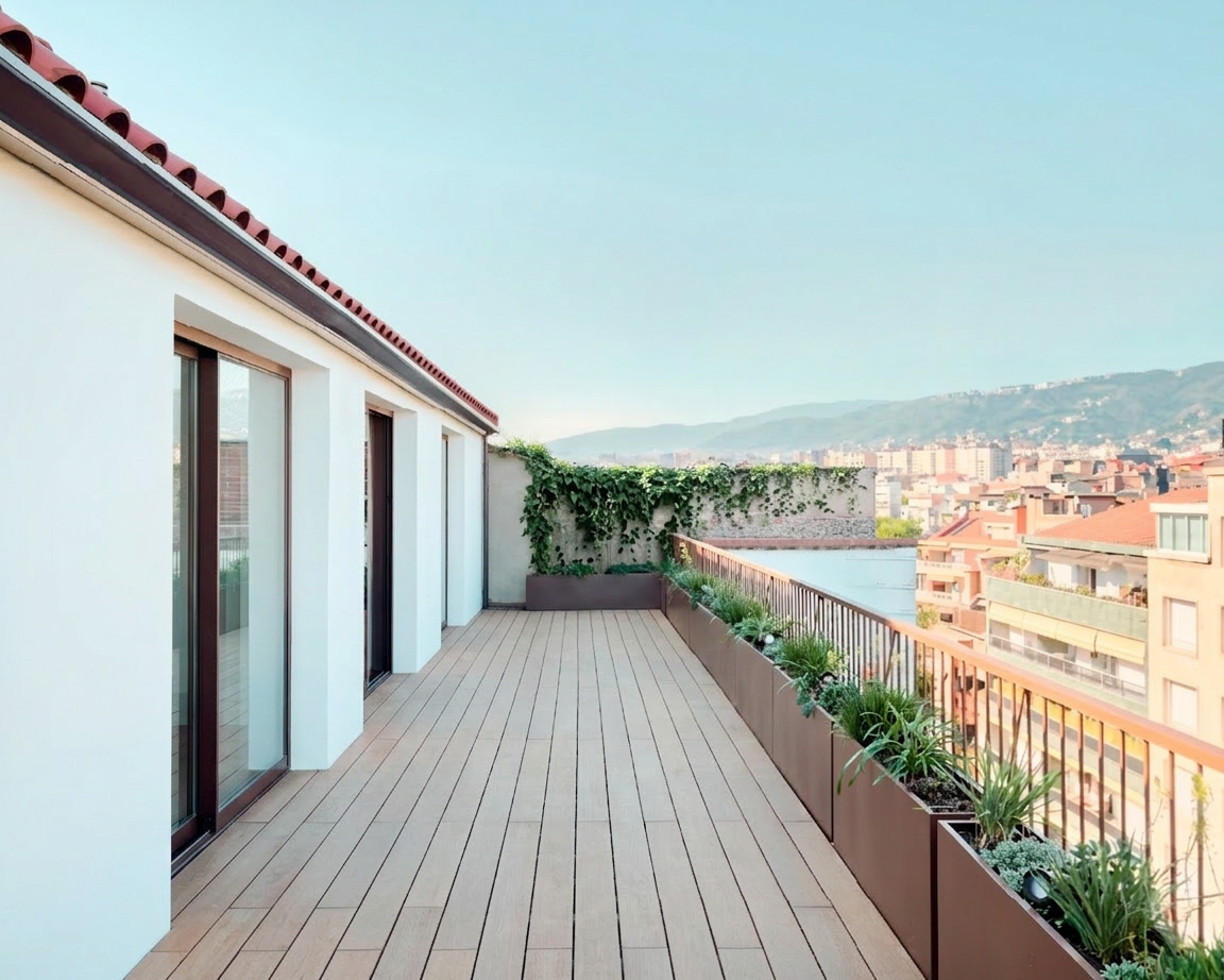 Private terrace with wooden decking and city views in a contemporary Barcelona penthouse