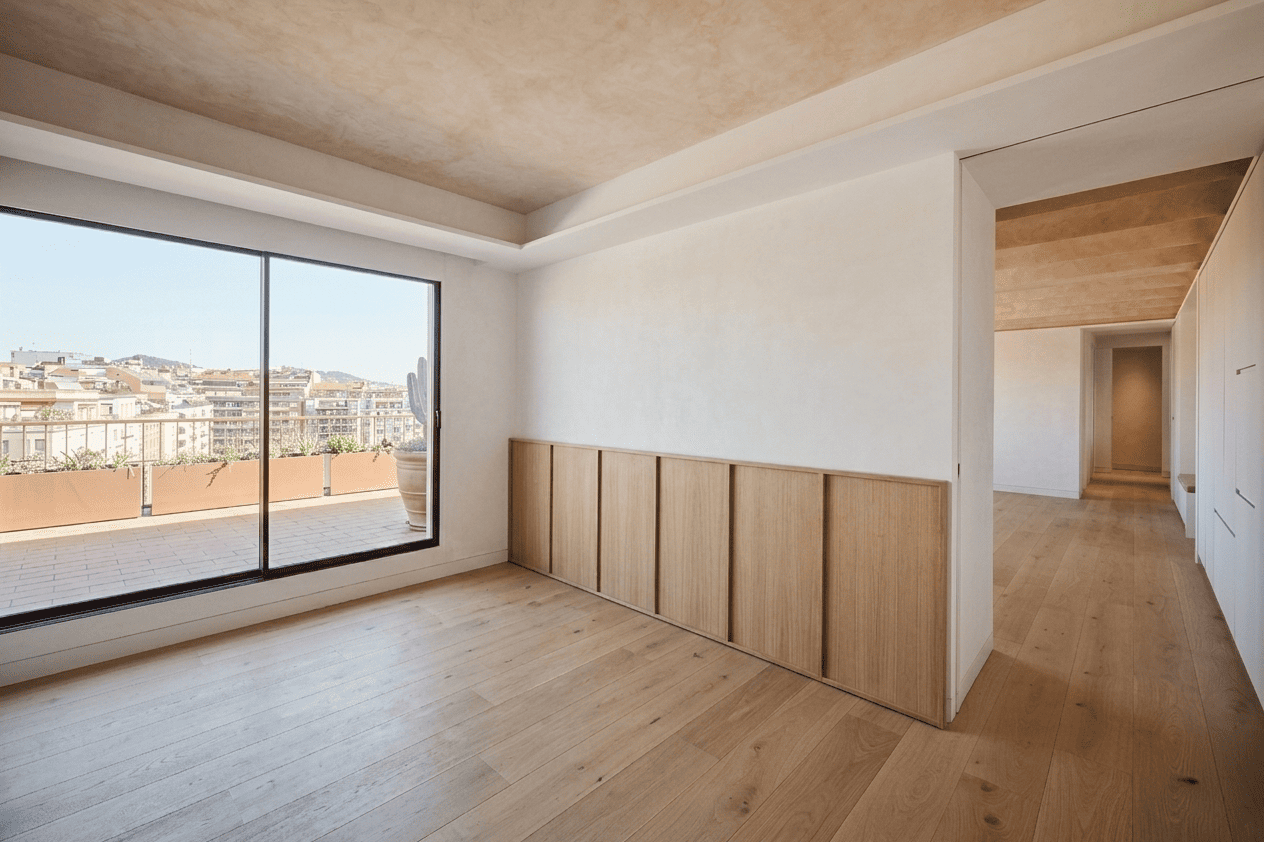 Minimal bedroom with oak flooring, custom wood paneling and terrace views in a Turó Park Barcelona apartment